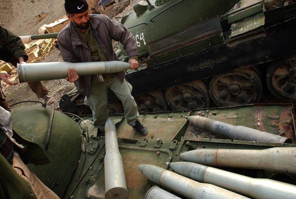 Afghan military personnel unload shells from a Russian tank to be collected by Afghan's New Beginning Programme (ANBP) in Panjshir Valley, about 120 kilometers (74 miles) north of Kabul, Afghanistan, Sunday January 9, 2005.