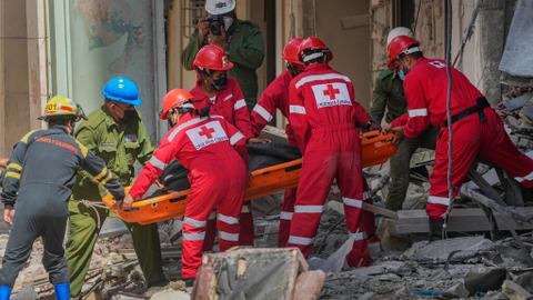 Rescuers recover a body at the site of Friday's deadly explosion that destroyed the five-star Hotel Saratoga, in Havana, Cuba, Saturday, May 7, 2022.