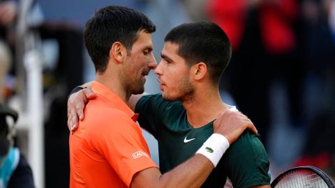 Novak Djokovic, left, shakes hands with Carlos Alcaraz at the end of a men's semifinal at the Mutua Madrid Open tennis tournament in Madrid, Spain, Saturday, May 7, 2022. Alcaraz won 6-7 (5-7), 7-5, 7-6 (7-5).